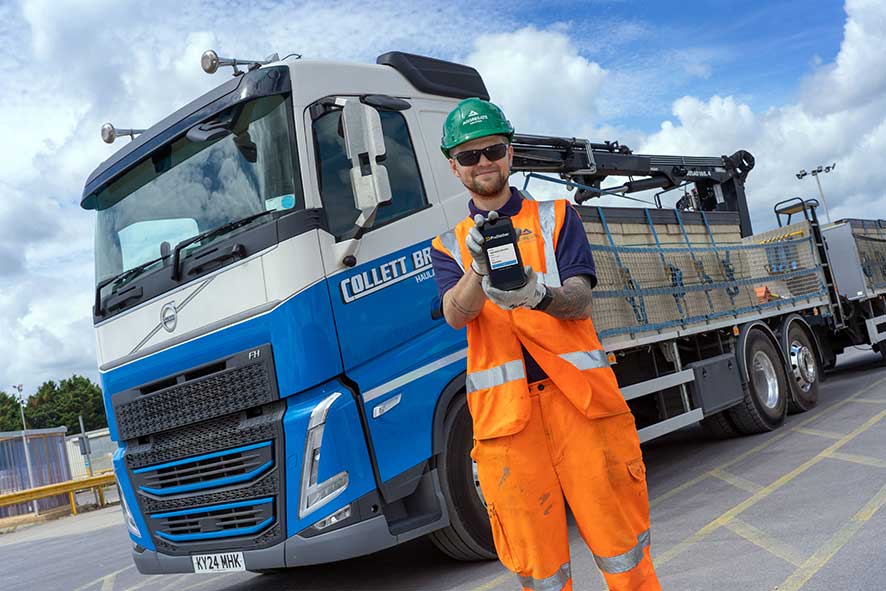 Aggregate Industries employee holding a device with Podfather login screen