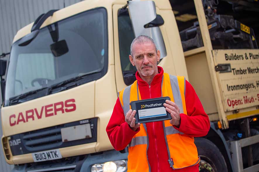 Carvers Building Supplies employee holding a device with Podfather