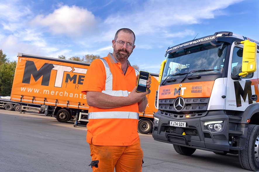 Merchants Transport employee holding a device with the Podfather login screen