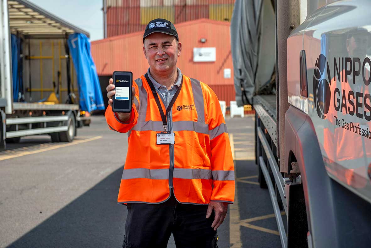 Nippon Gases employee holding a device with a Podfather screen