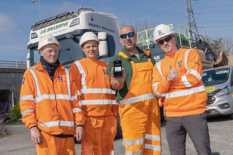 J.C. Gillespie employees holding phone with Podfather system showing