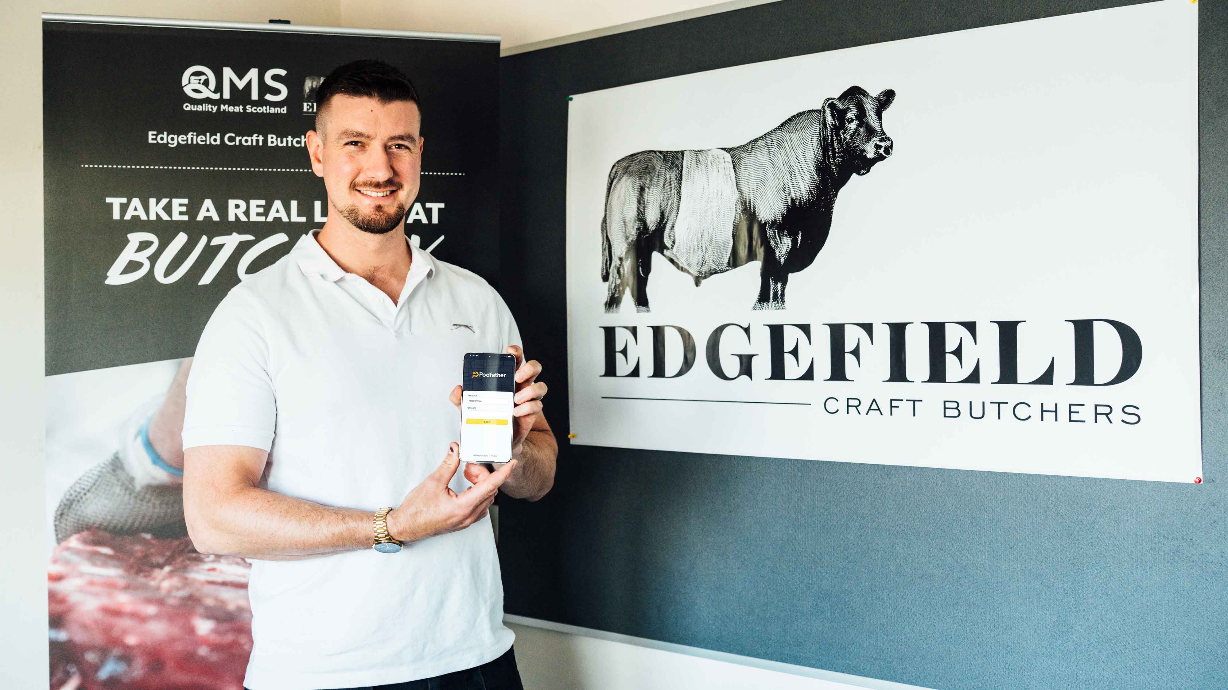 Edgefield employee standing holding mobile device with Podfather on it