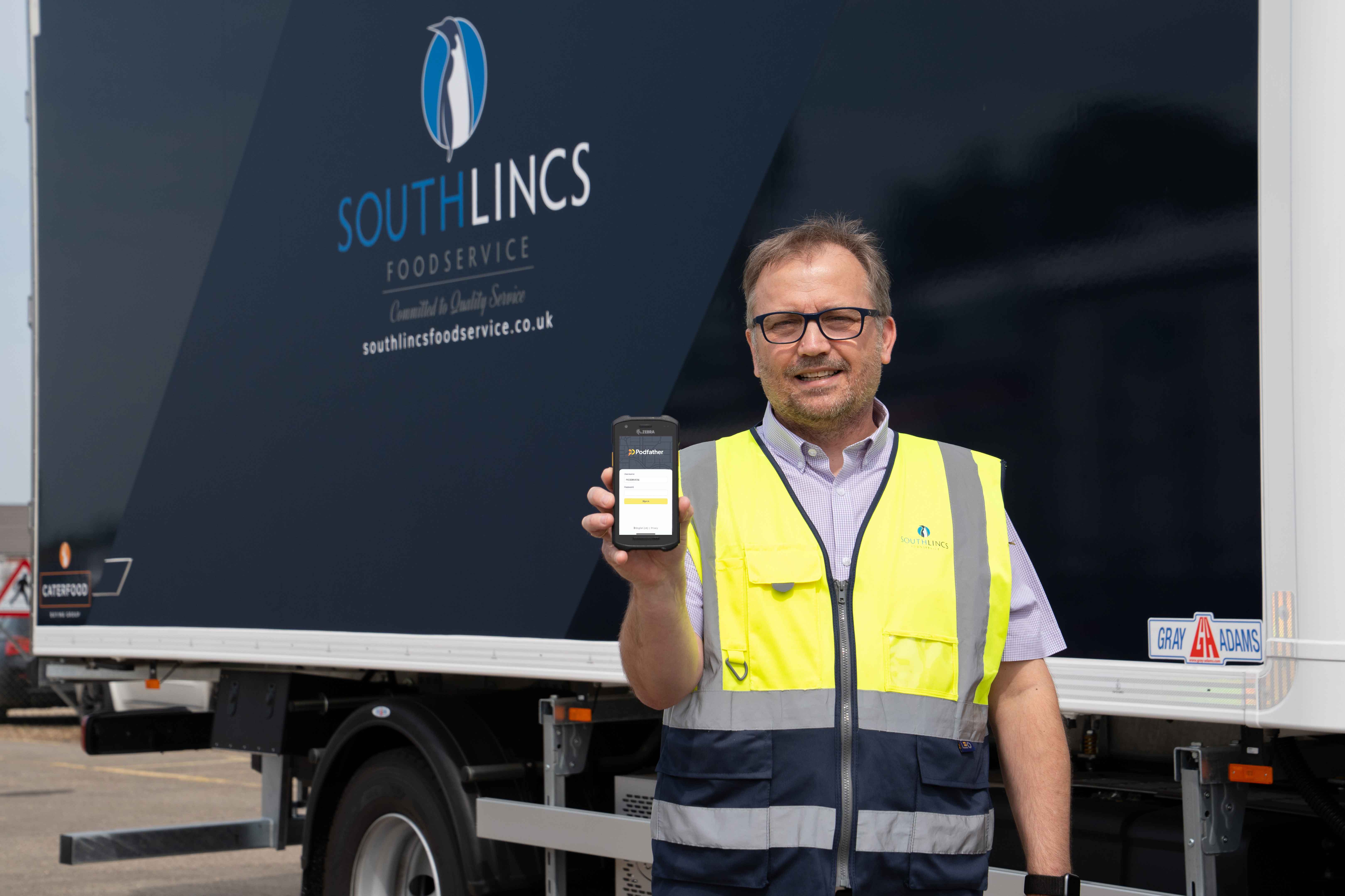 South Lincs Foodservice employee holding phone with Podfather on it