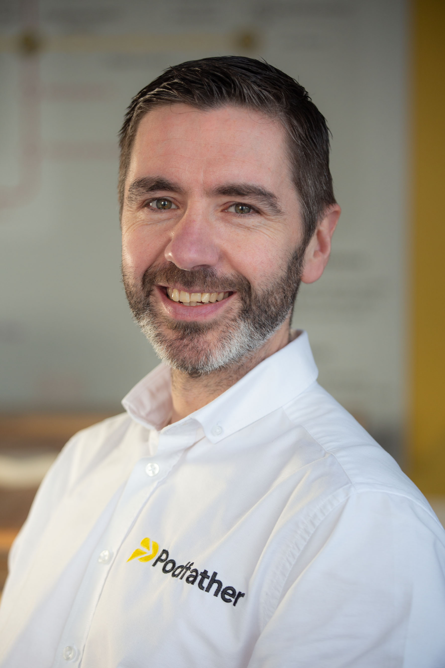 smiling man wearing a white shirt