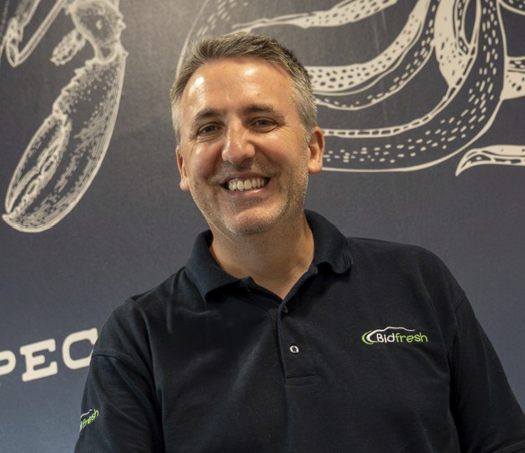 smiling man in a navy polo shirt