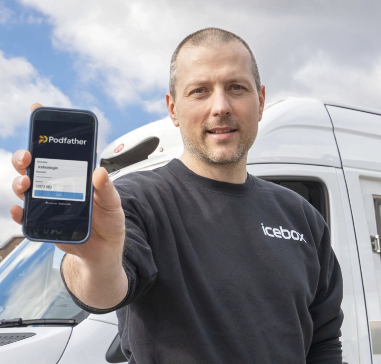 man wearing a black jumper holding a mobile device 
