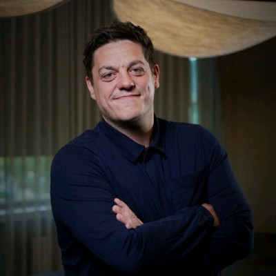 smiling man looking at the camera with his arms crossed