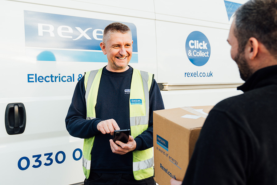 Rexel delivery driver standing in front of a van