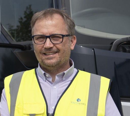 Man wearing glasses smiling at the camera